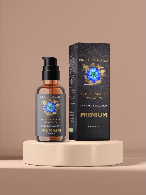 Glass bottle with pump of Premium nigella oil next to its packaging on a podium with a peach-colored background.