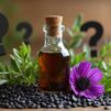 A bottle of black seed oil surrounded by black seeds, flowering Nigella sativa plant and question marks.